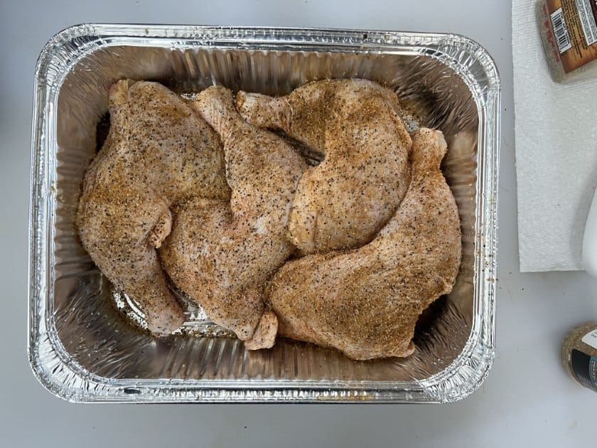 Seasoned chicken quarters hanging out in a dry brine.