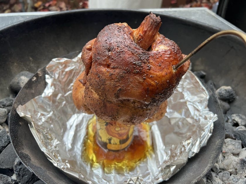 Beer can chicken on the Weber Kettle with a temp probe sticking out.