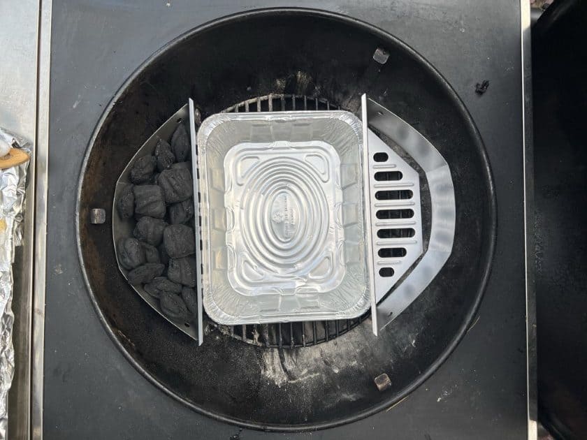 Charcoal baskets, unlit briquettes, drip pan, inside a weber kettle.