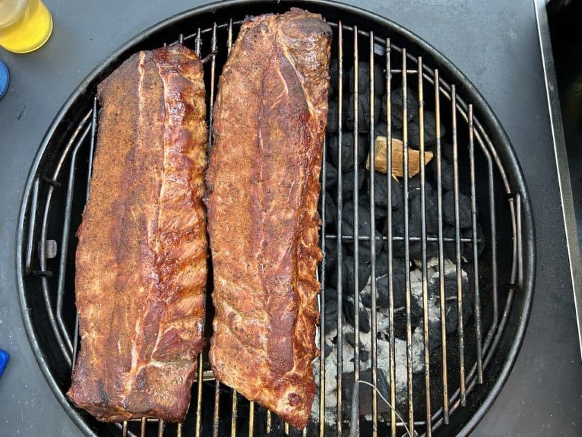 Checking on ribs on the Weber kettle.